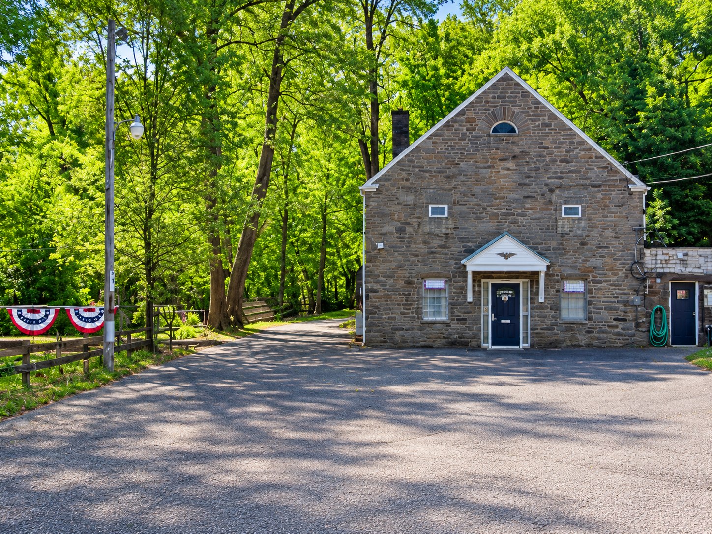 Exterior of American Legion Post 497 surrounded by trees